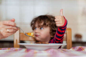 Mother feeding her baby boy