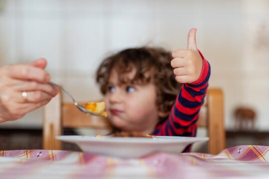 Mother feeding her baby boy