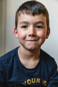 Optimistic boy giggling at home