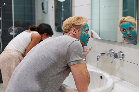 Couple washing off face masks - Powered by Adobe