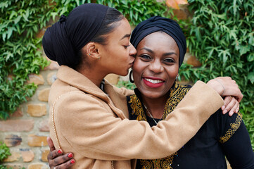 Smiling Muslim women having coffee