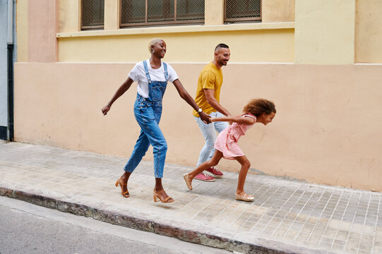 Running family walking on a sidewalk