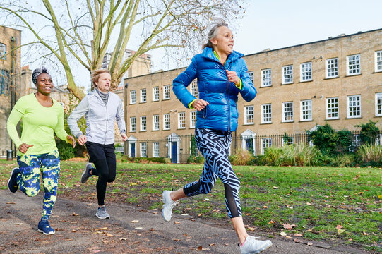 Mature friends running in a park