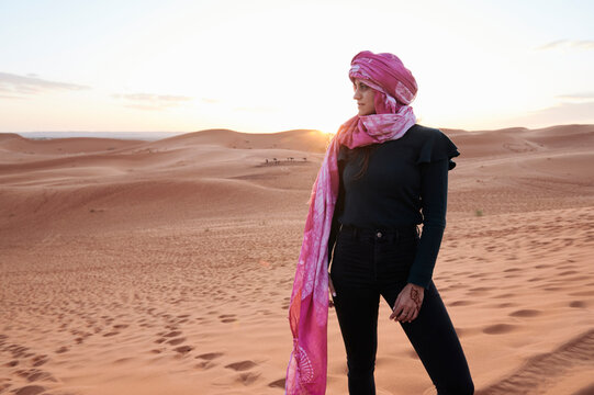 Young woman turban desert sunset