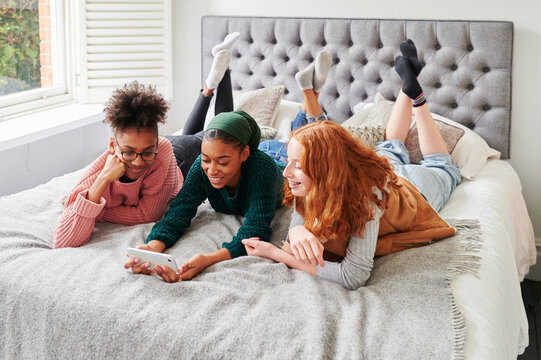 Teen girls watching something on a cellphone