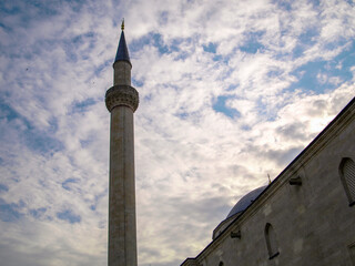 Fototapeta na wymiar Selimiye Mosque is an Ottoman imperial mosque, the most famous historical monument of Edirne, located in the European part of Turkey. Dramatic minaret silhouette with blue sky and white clouds.