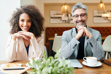 Smiling businesspeople sitting in a cafe