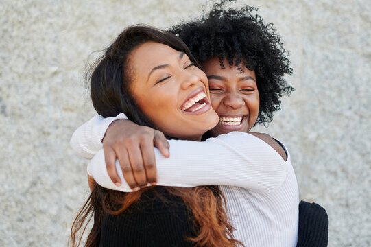 Laughing Friends Hugging Outside