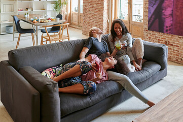 Laughing friends hanging out at home