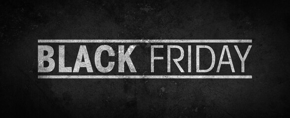 Black Friday inscribed in white on a black textured background - black grunge cement texture - high resolution background