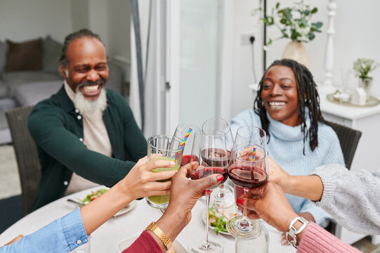 Laughing family toasting at dinner