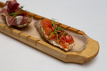 Canapes on a wood plate finger food party food catering 