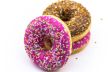 pink and brown doughnut. Strawberry and raspberry doughnuts. Walnut donut on a white background.