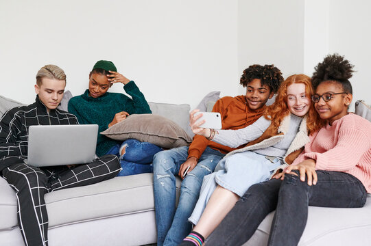 Teen friends hanging out on a sofa