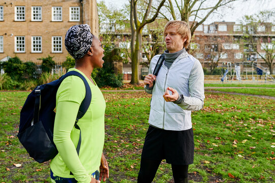 Smiling friends talking in a park - Powered by Adobe
