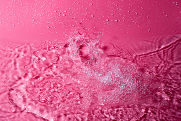 splash of water on a red background. Abstract wallpaper