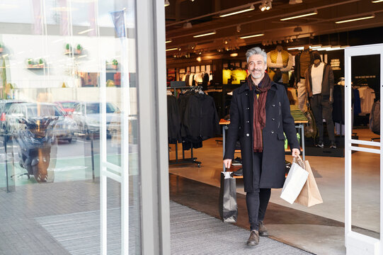 Stylish Man Walking Out Of A Store