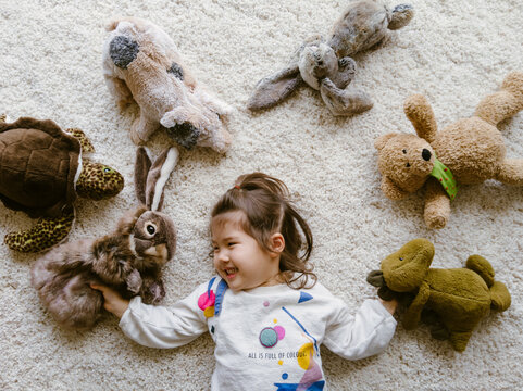 Little girl with stuffed animals