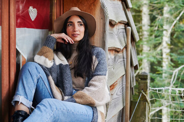 Smiling woman sitting by a cabin window