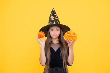 kid hold spooky pumpkin. witchcraft and enchantment. childhood autumn holiday. teen girl ready to...