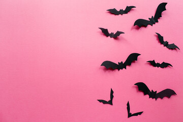 Halloween decorations with bats on pink background. Halloween concept. Flat lay, top view, copy...