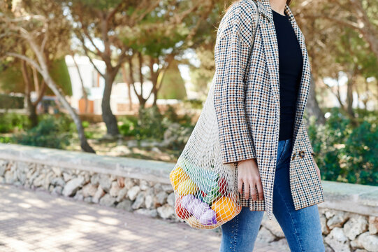 Woman walking with a bag of vegetables