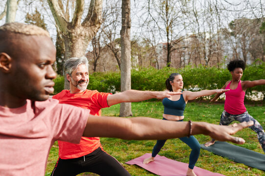 Yoga students practicing in a park