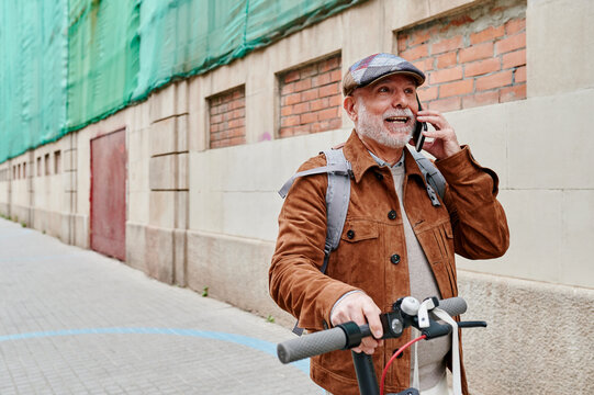 Senior man talking on his cellphone in the city