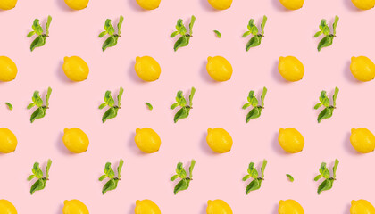 Bright pattern of fresh whole lemons and mint on a pink background. Citrus, vitamin C, fruit.