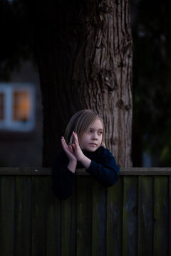 Little girl claps for essential workers.