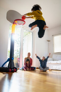 Nine year old boy playing basketball indoor