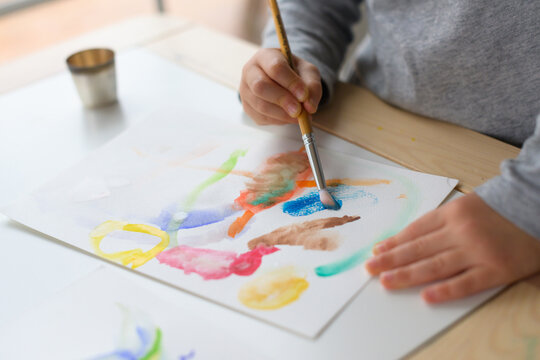 Child painting with watercolors