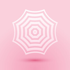 Paper cut Sun protective umbrella fo beach icon isolated on pink background. Large parasol for outdoor space. Summer vacation or picnic accessory. Paper art style. Vector. © mingirov