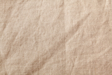 Beige textile linen tablecloth in full frame. Cloth texture background. Copy space.