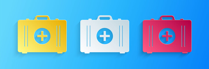Paper cut First aid kit icon isolated on blue background. Medical box with cross. Medical equipment for emergency. Healthcare concept. Paper art style. Vector.