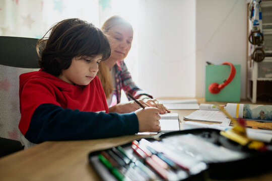 Mother Help His Nine Year Old Son With His Homework