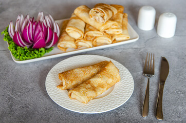 Thin Russian pancakes (crepes)  with chicken and cheese.