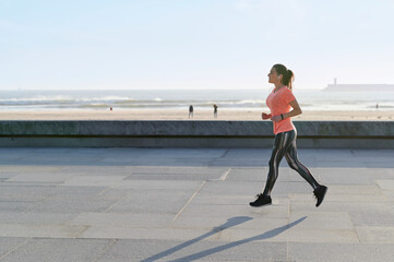 Mature woman running on a promenade