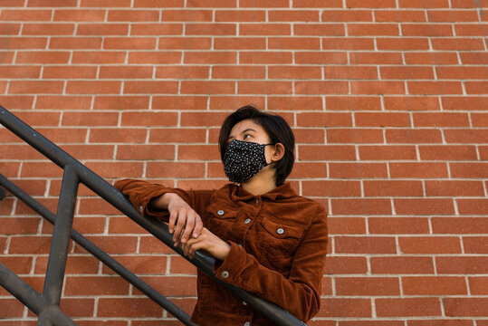 woman on stair case with mask