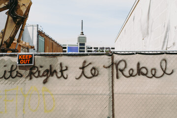 Protest graffiti on city fence during riot looting