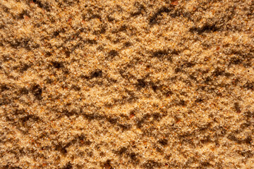 Beautiful sandy light brown background bake for design. Close-up of sand surface 