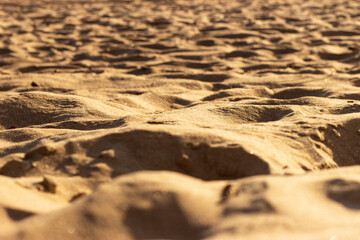 Uneven surface of sand on the beach at the seaside on a sunny day.