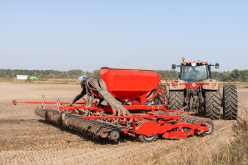 The tractor harvester working on the field