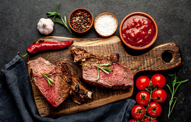 Baked beef on the bone with spices on a stone background