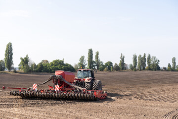 The tractor harvester working on the field