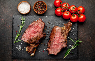Baked beef on the bone with spices on a stone background