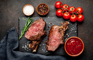 Baked beef on the bone with spices on a stone background