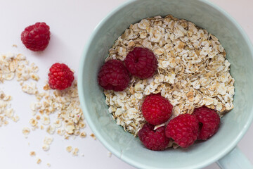 healthy Breakfast oatmeal porridge and fruit berries on a white background