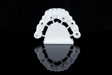 Milled raw zircon dental prosthesis for patient after milling machine, lower jaw.
