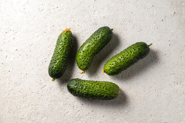 Farmer cucumbers top view on light concrete background